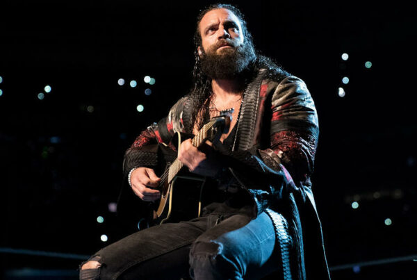 Elias plays his guitar in WWE