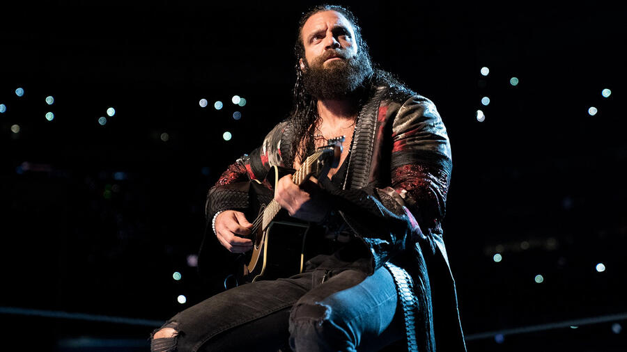Elias plays his guitar in WWE